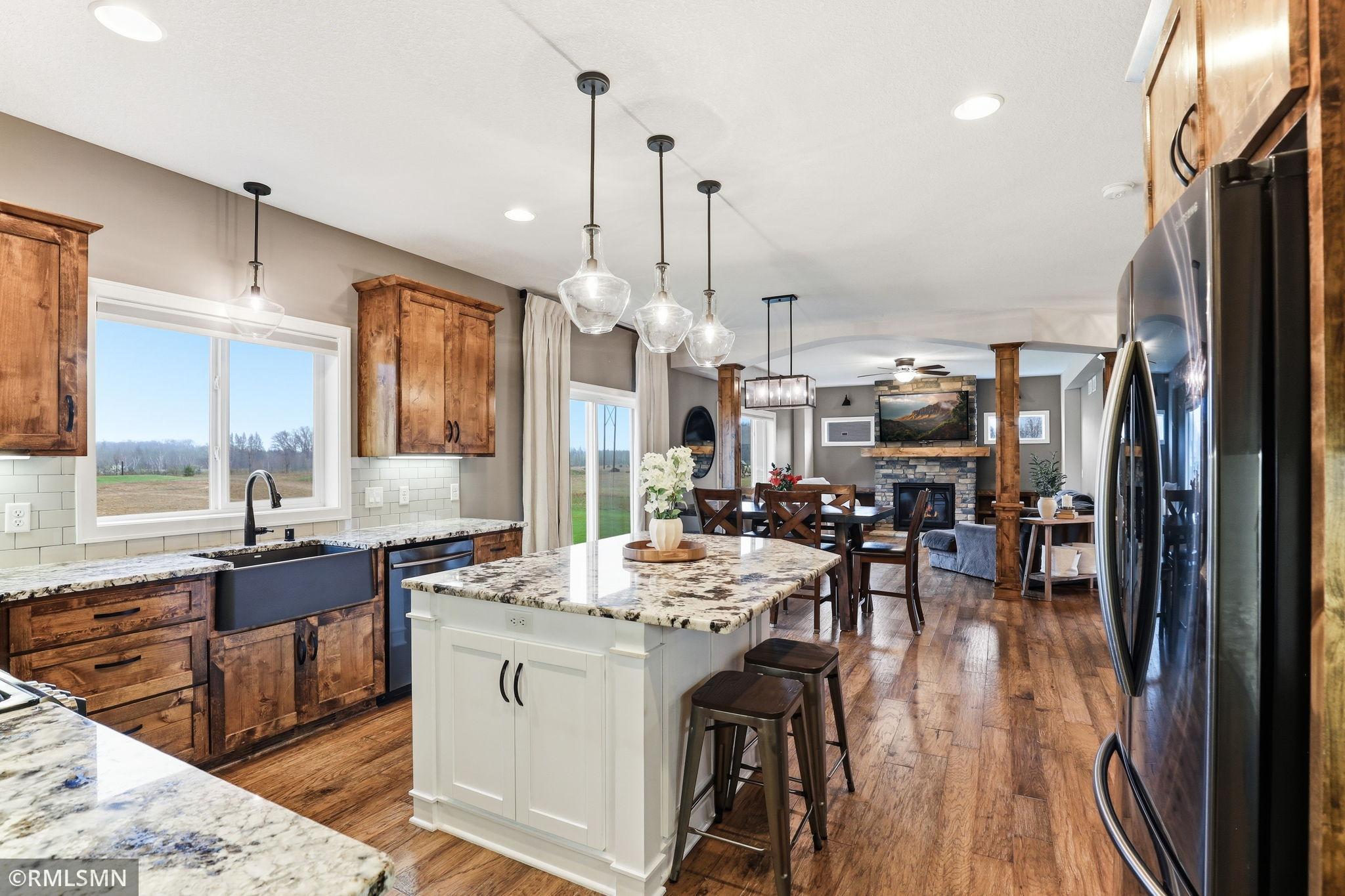 Entertain effortlessly with a layout that flows from kitchen to dining to living space. Host gatherings, keep conversations going, and enjoy the warmth of the fireplace just steps away.