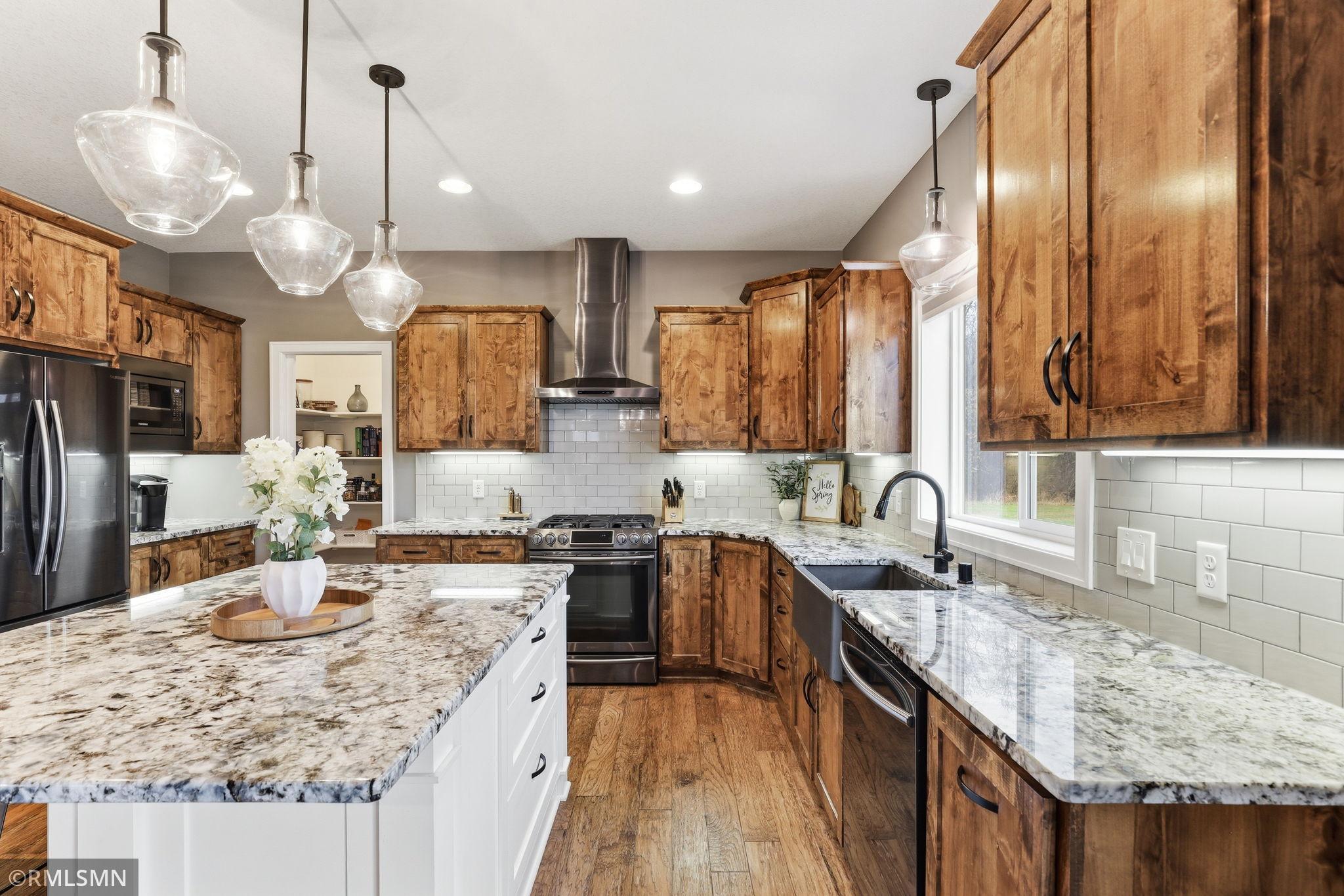 Cook with ease in this well-designed kitchen featuring granite countertops, stainless steel appliances, and abundant cabinetry. Enjoy the functional layout that keeps everything within reach while entertaining.