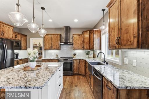 Cook with ease in this well-designed kitchen featuring granite countertops, stainless steel appliances, and abundant cabinetry. Enjoy the functional layout that keeps everything within reach while entertaining.