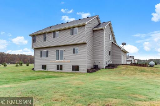 Appreciate the expansive backyard and rear elevation featuring multiple daylight windows, offering great potential to expand outdoor living or finish the lower level to fit your needs.
