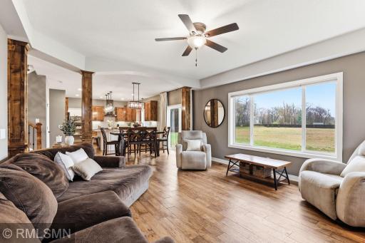 Enjoy the open-concept layout as you relax in the spacious living room or gather with friends and family in the dining area. Large windows fill the space with natural light and offer peaceful views of the surrounding acreage.