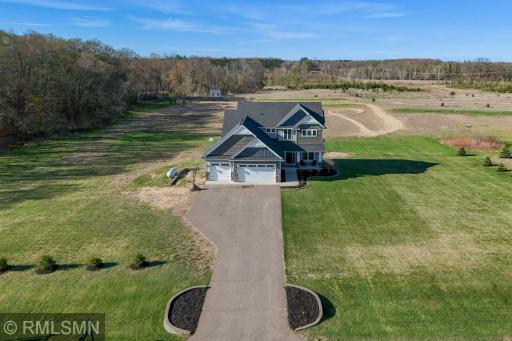 Welcome home to a beautifully designed exterior with a 3 car garage, inviting front porch, and spacious driveway, all set on a private 3 acre lot with room to enjoy the outdoors!