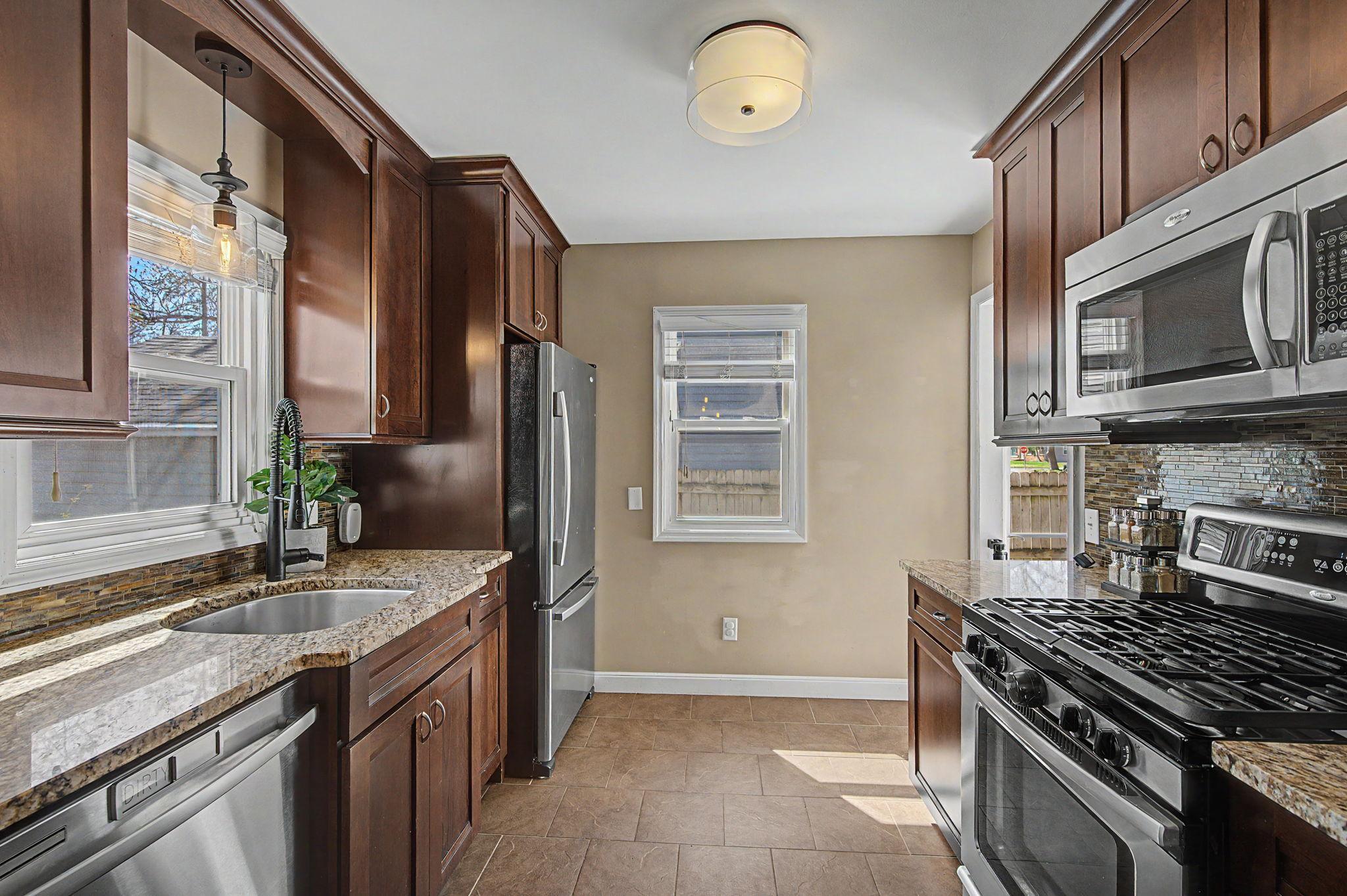 Kitchen Features Gas Stove and Stainless Steel Appliances
