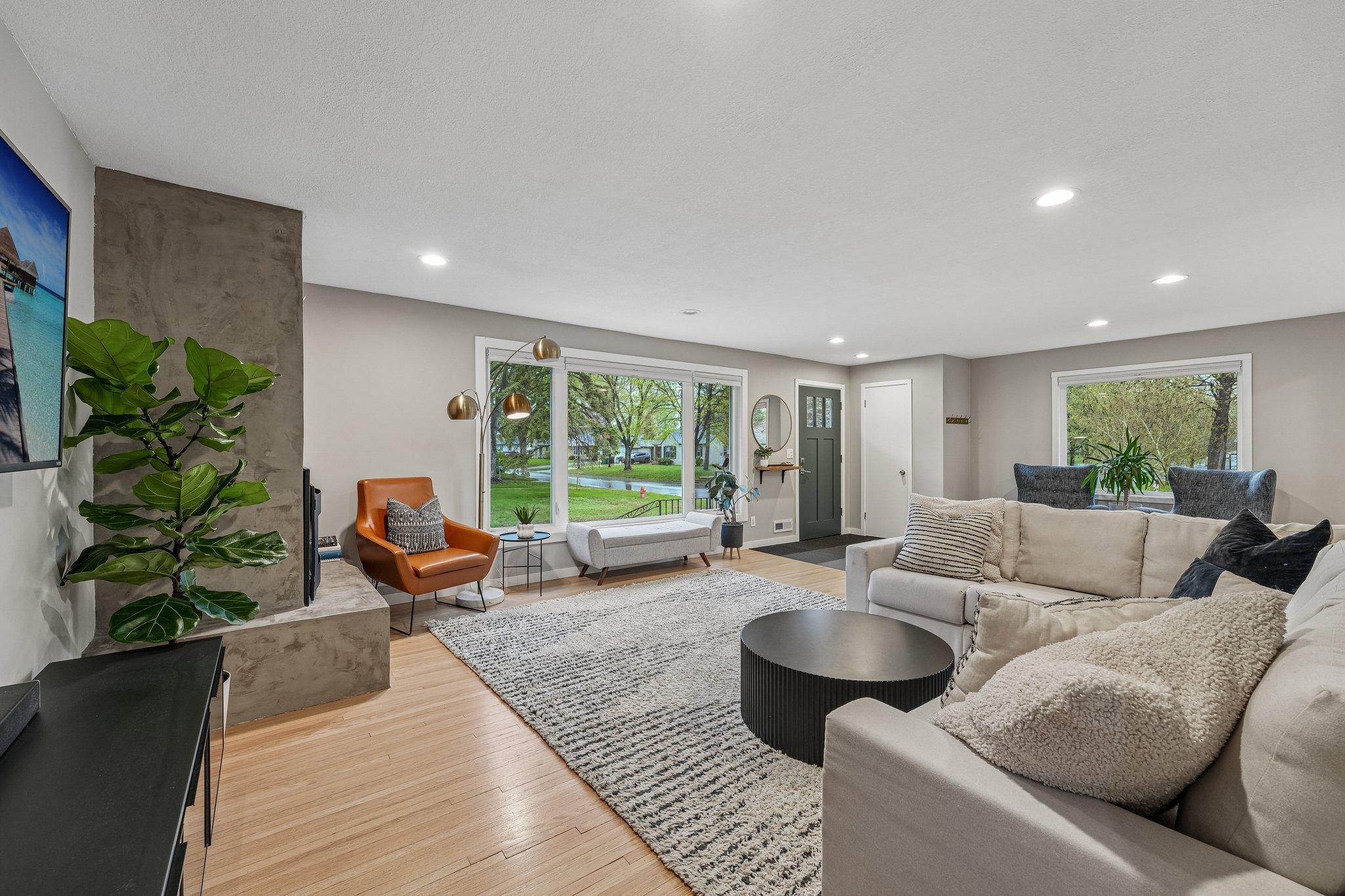 A light-filled living room featuring new windows that beautifully enhance its mid-century modern charm, creating a bright and inviting space with classic elegance.