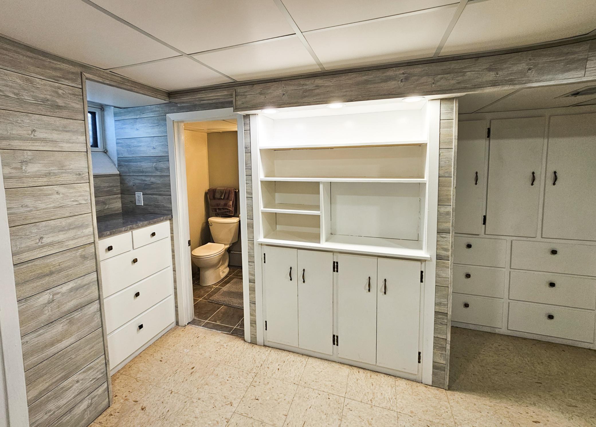 The dedicated workspace features fresh flooring, integrated shelving