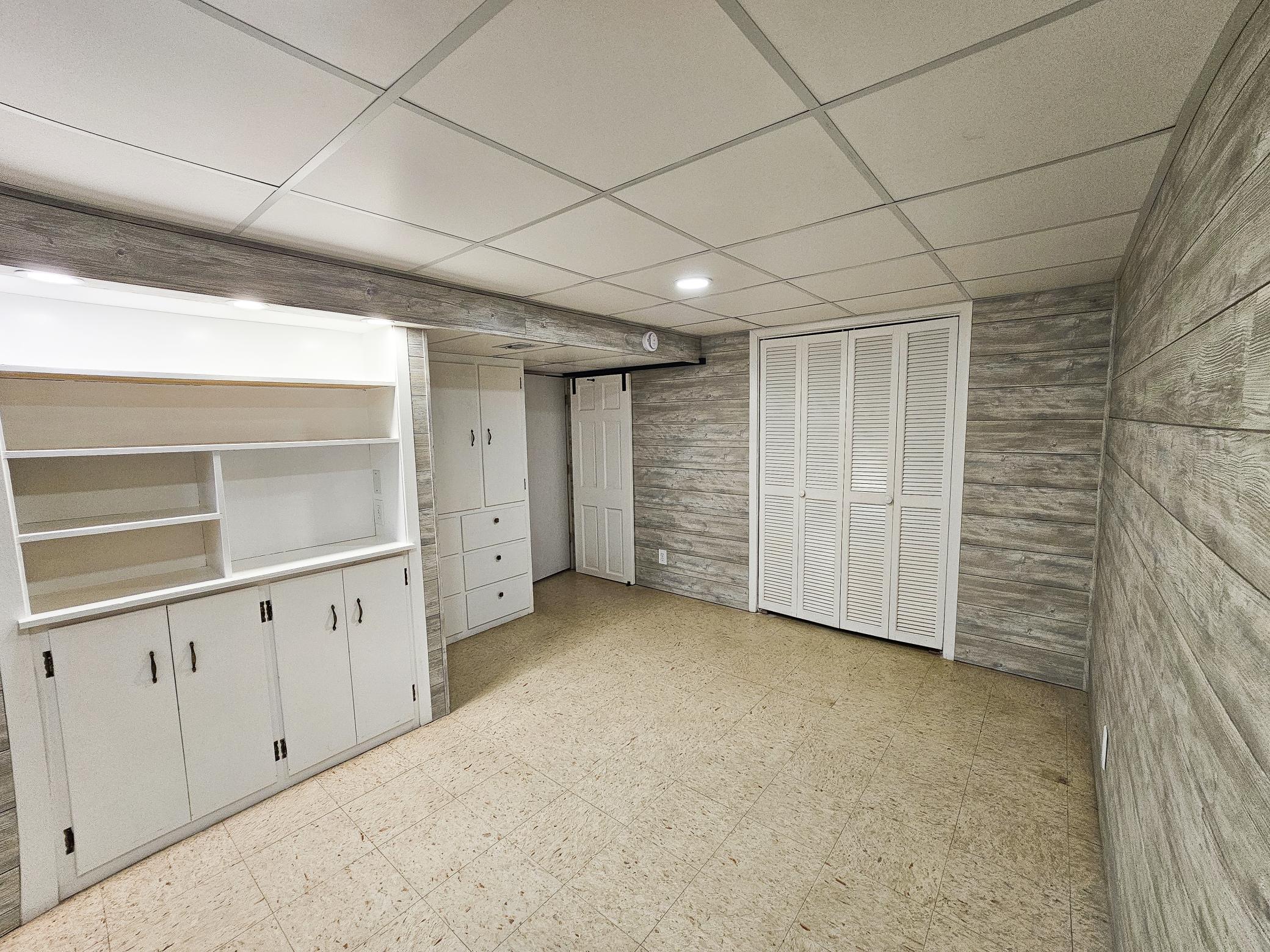 Closet shelving, and expansive storage space are steps away from this office.
