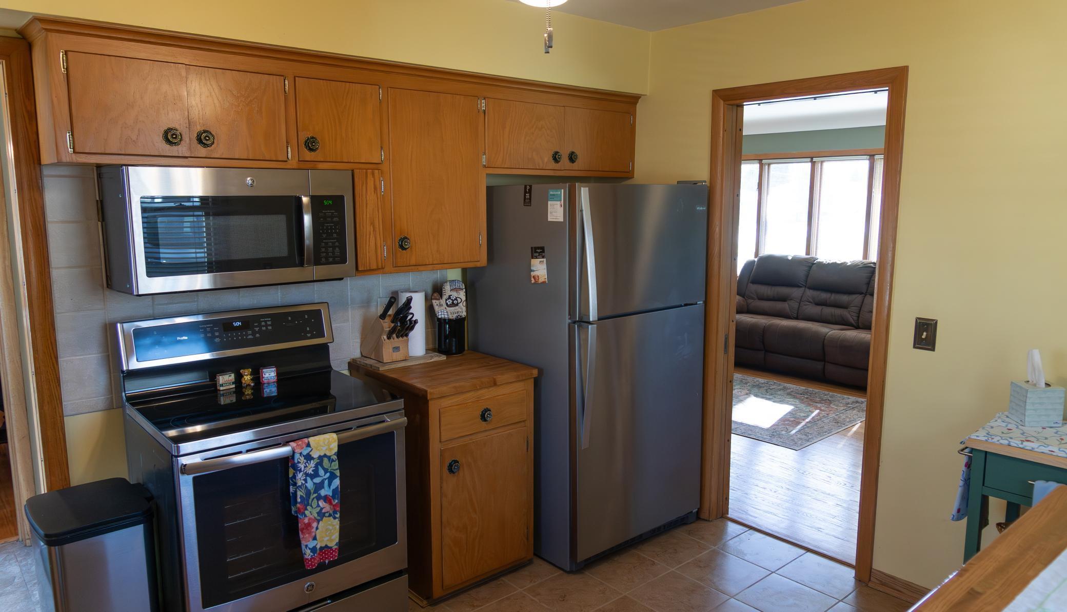 Newer stainless-steel appliances, tile floors, and ceiling fan
