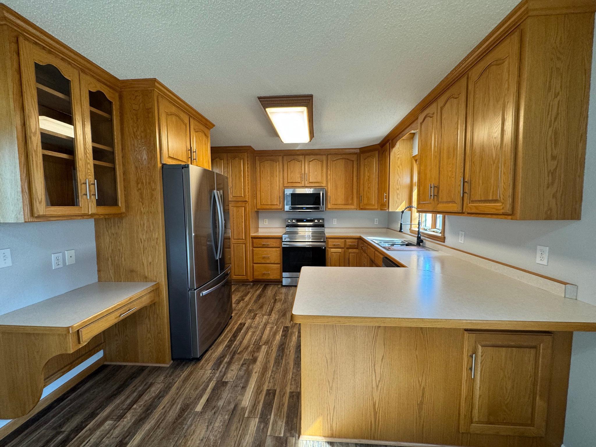 Spacious kitchen with breakfast bar and newer appliances.