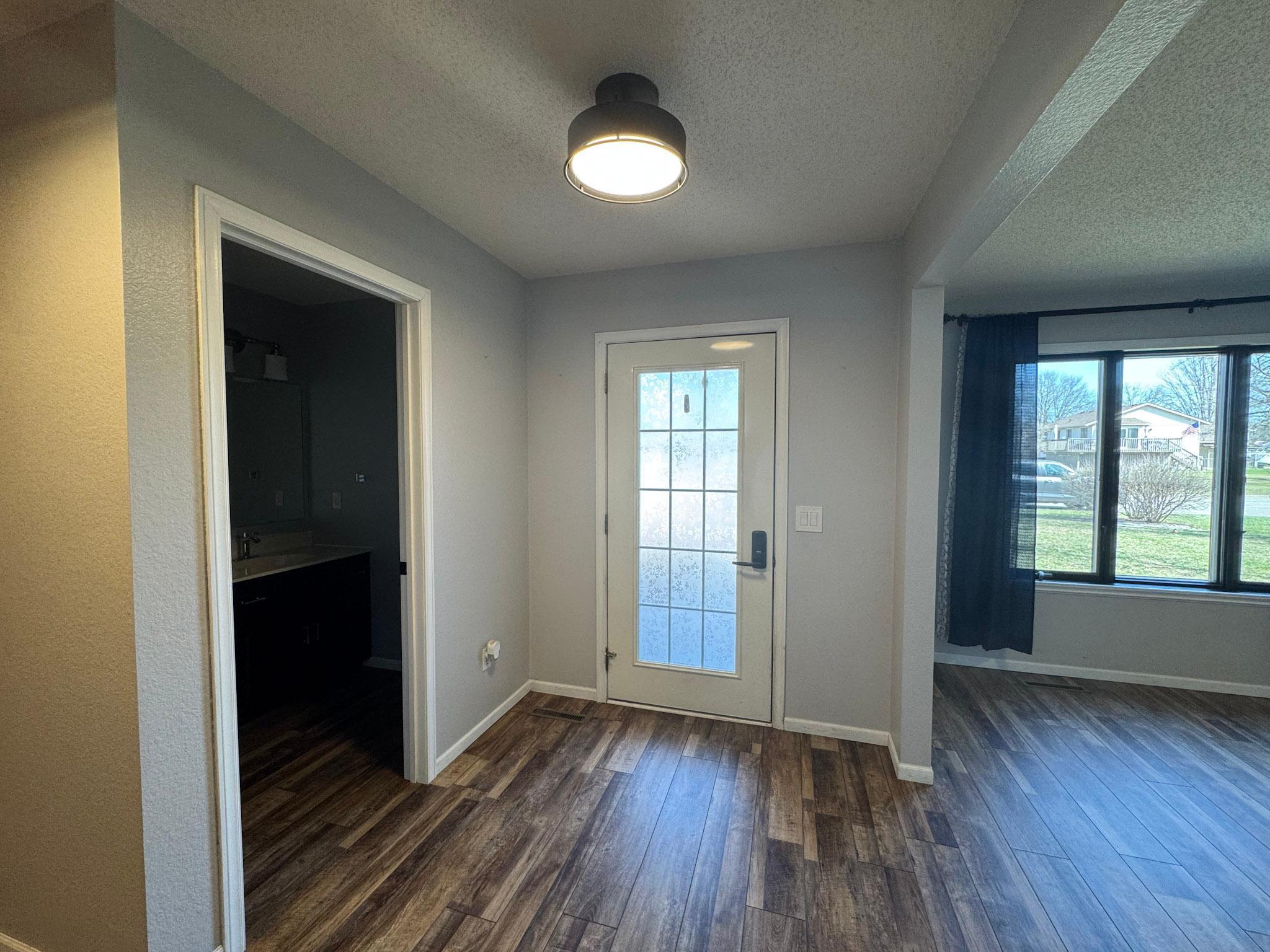 Front entry with view of the 1/2 bathroom and formal dining or office.