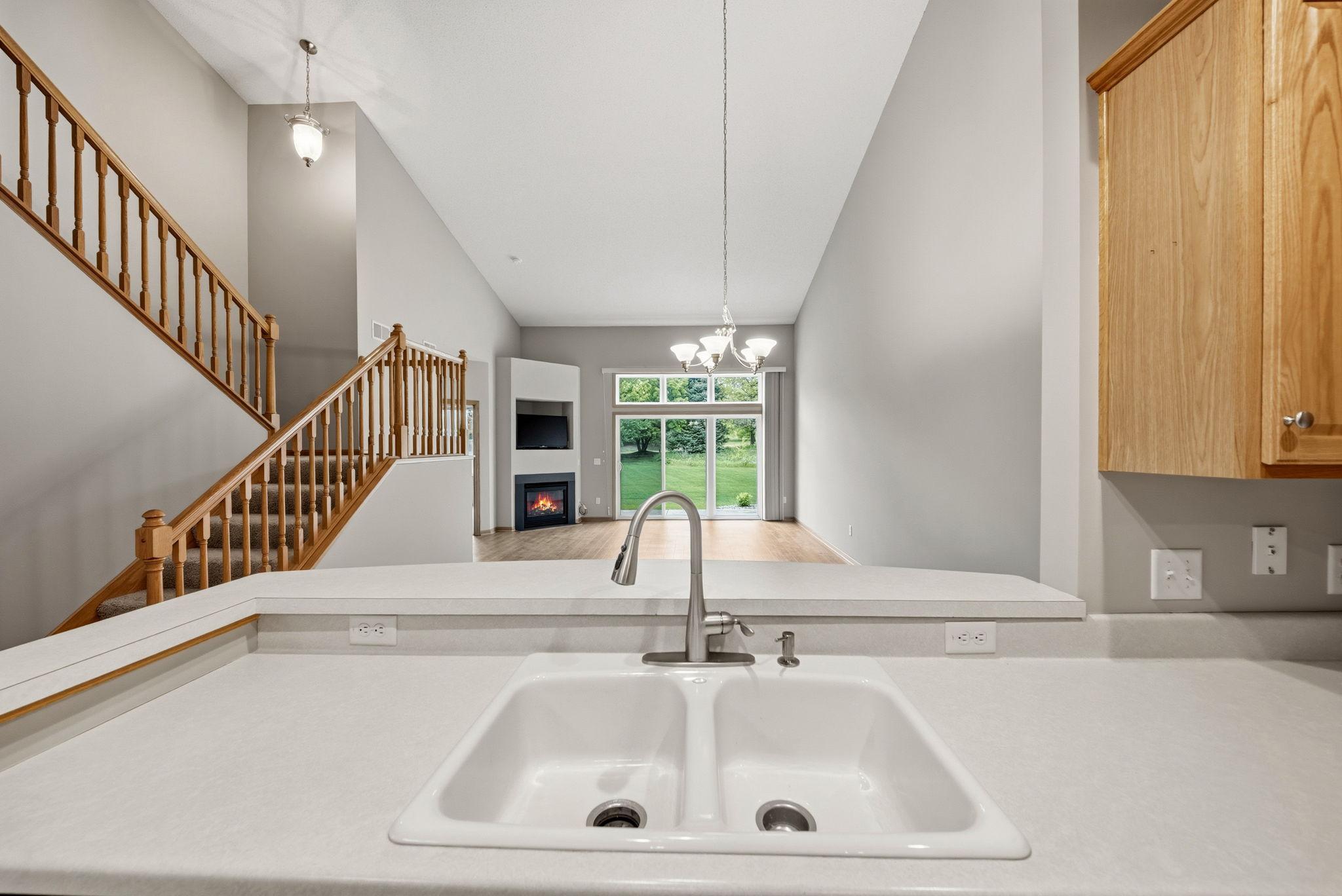 Kitchen facing the dining and living room. Breakfast bar behind the sink.