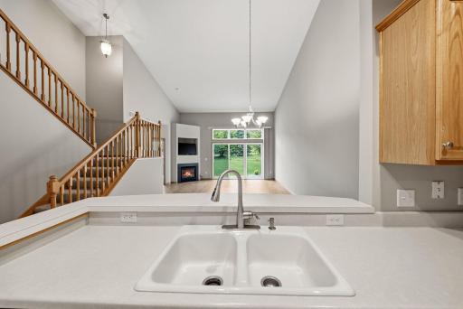 Kitchen facing the dining and living room. Breakfast bar behind the sink.