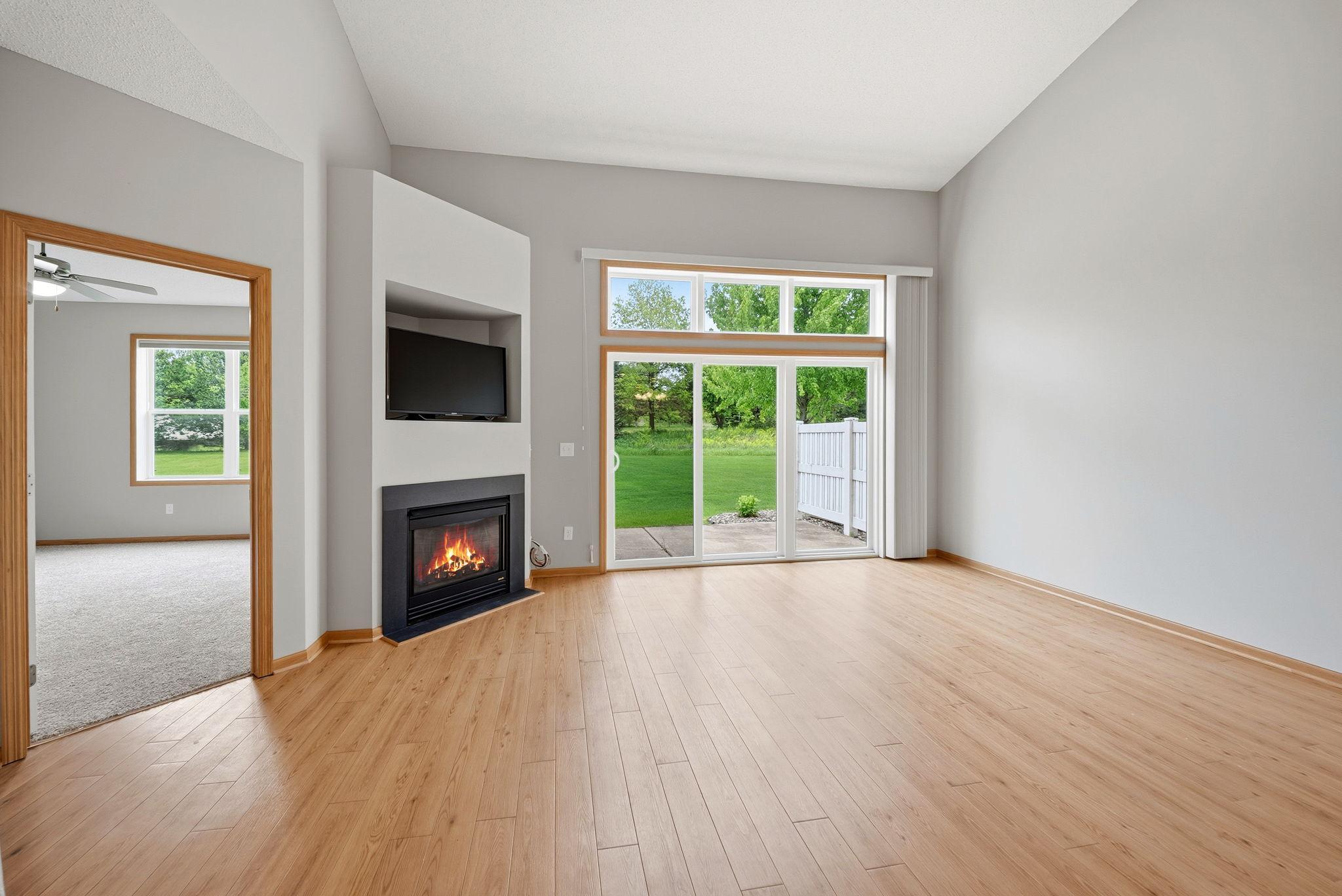 Living room with fire place and the sliding door to the patio.