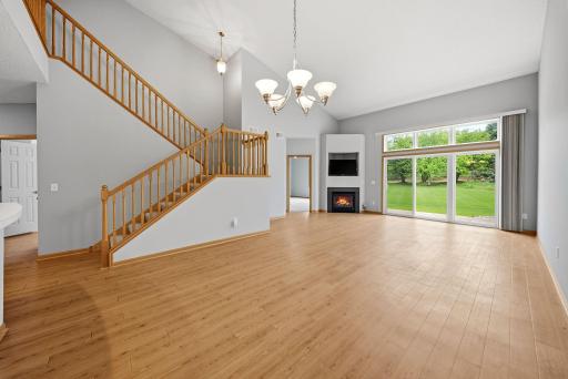 Dining and living room with gas fireplace and sliding door to the patio.