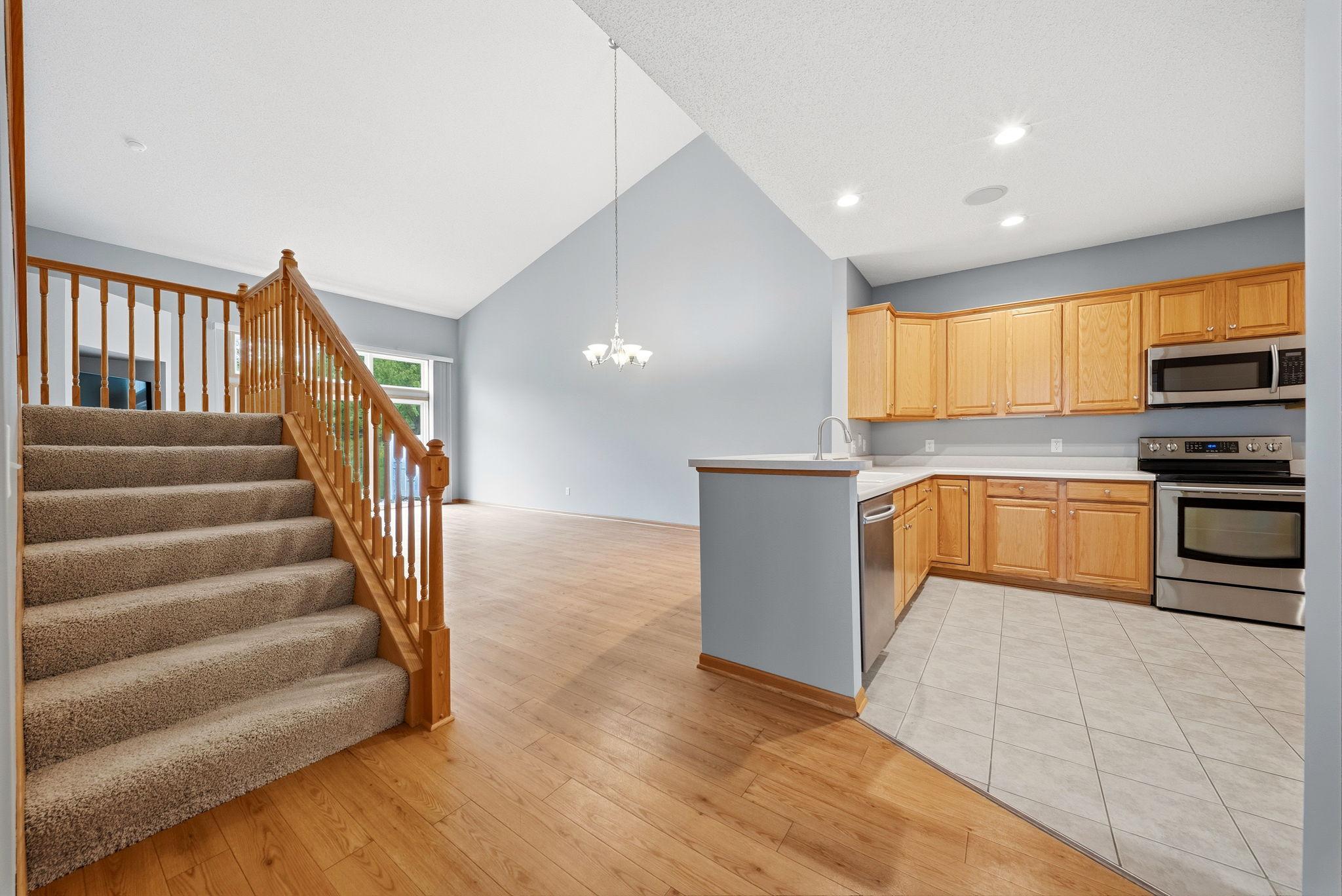 Kitchen to the right, dining straight ahead, and stairs to the loft to the left.