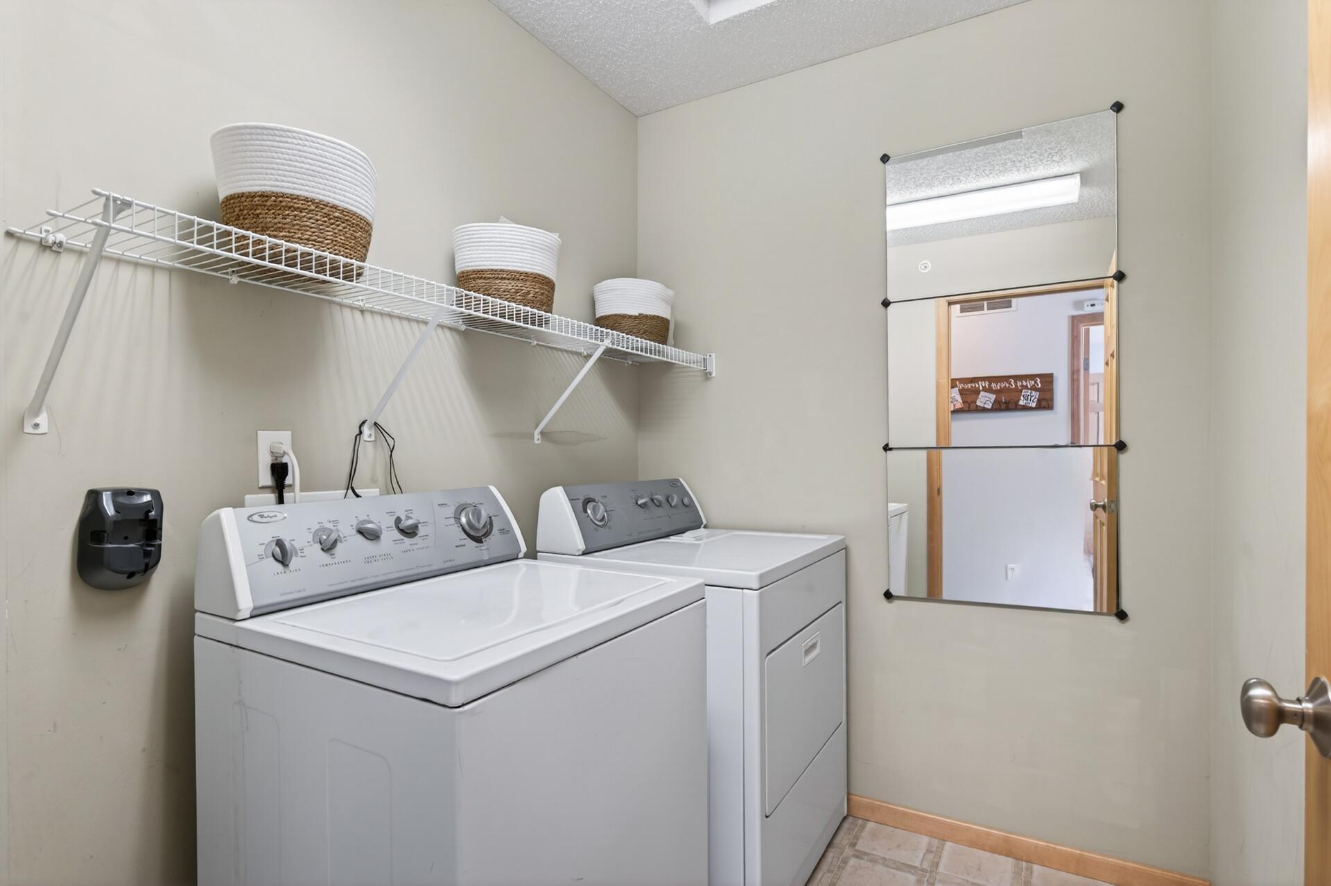 The dedicated laundry room is located just across the hall from the bathroom.
