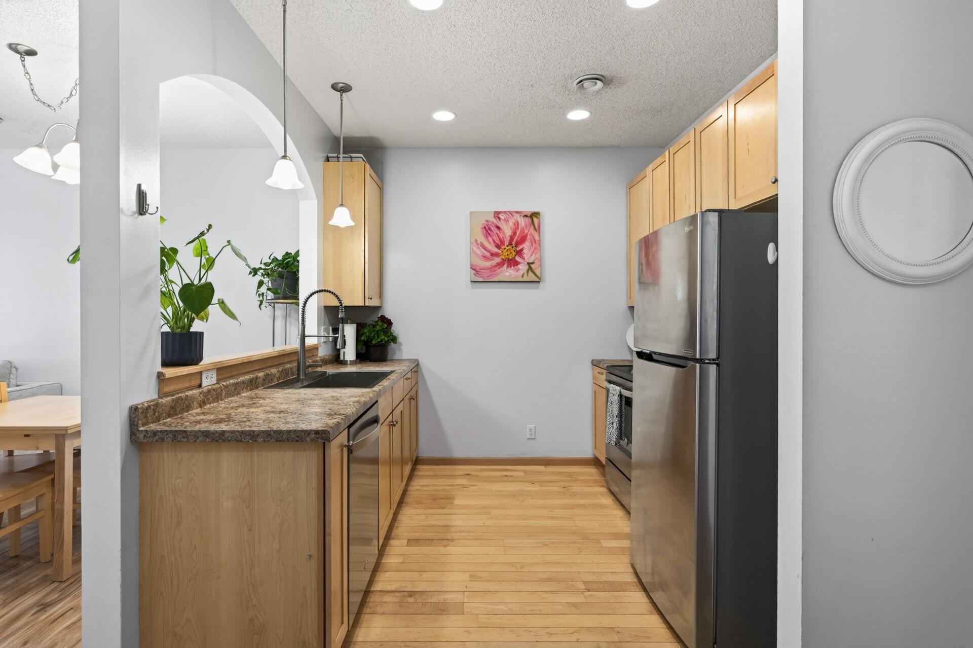 The kitchen features stainless steel appliances, a new garbage disposal, and tons of storage space!