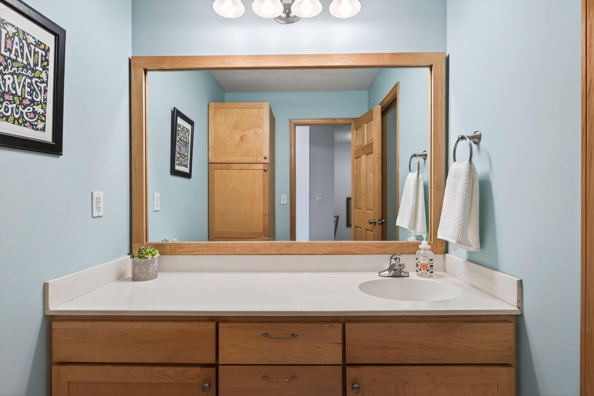 The upstairs bathroom has TONS of storage and a large vanity - the perfect spot to get ready in the morning!