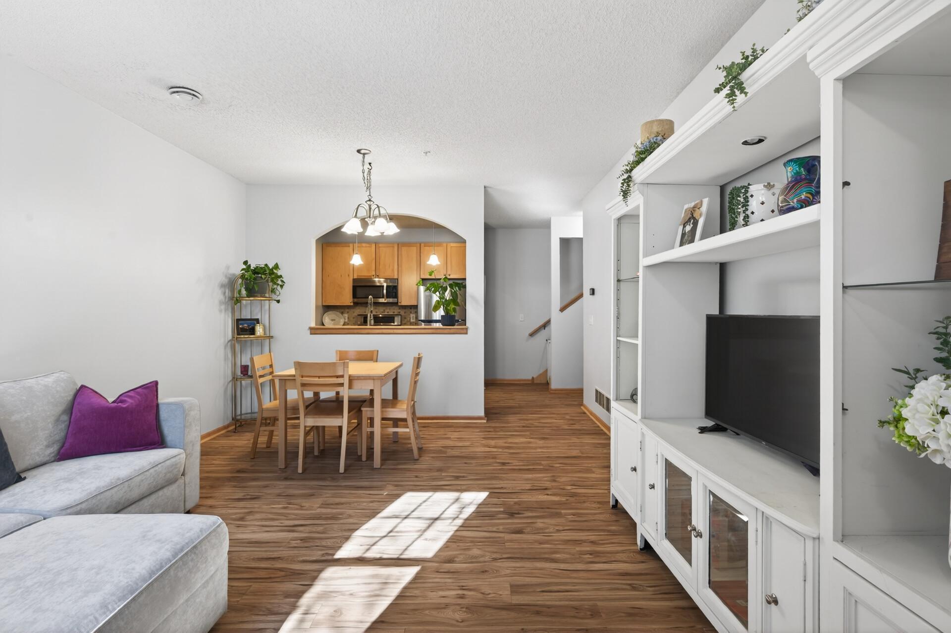The sunny living room flows effortlessly into the dining area and kitchen - perfect for entertaining!