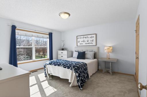 Upstairs primary bedroom with oversized windows and a large walk-in closet.