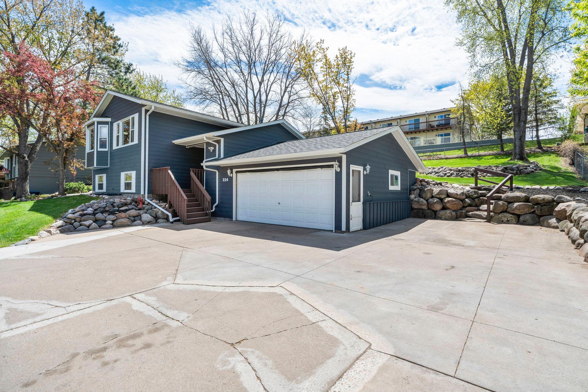 Rock landscaping surrounds ample parking