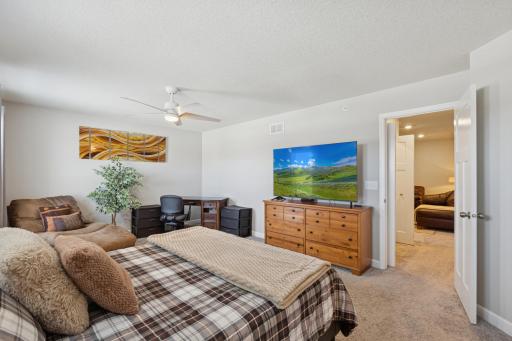 Primary bedroom is flooded with natural light