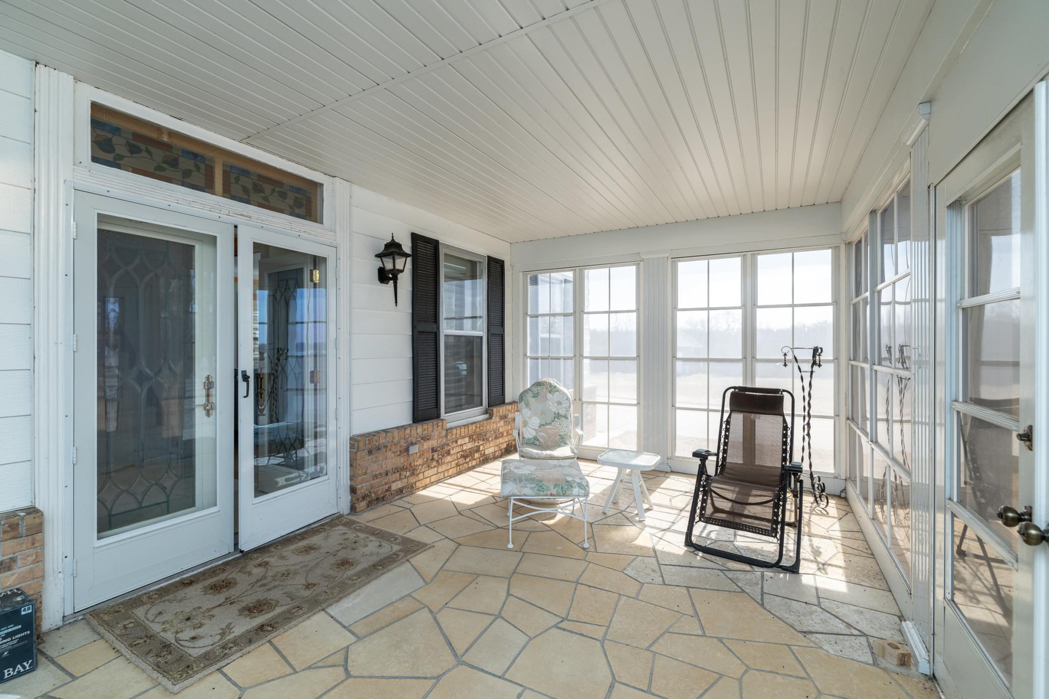 Spacious 22 x 12 enclosed with Flagstone flooring and views of the lake