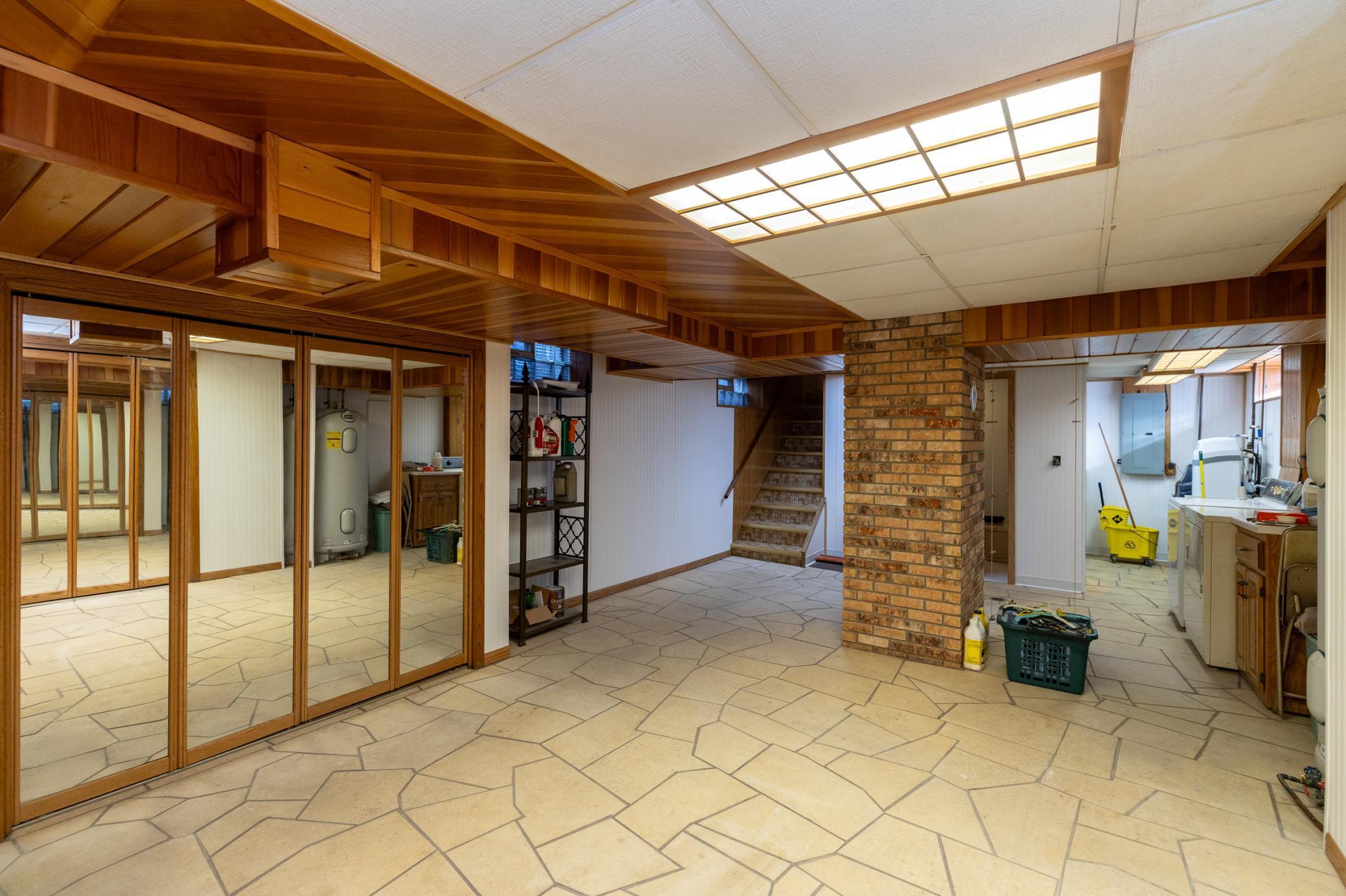 The finished lower level features flagstone flooring that matches that in the two porch areas