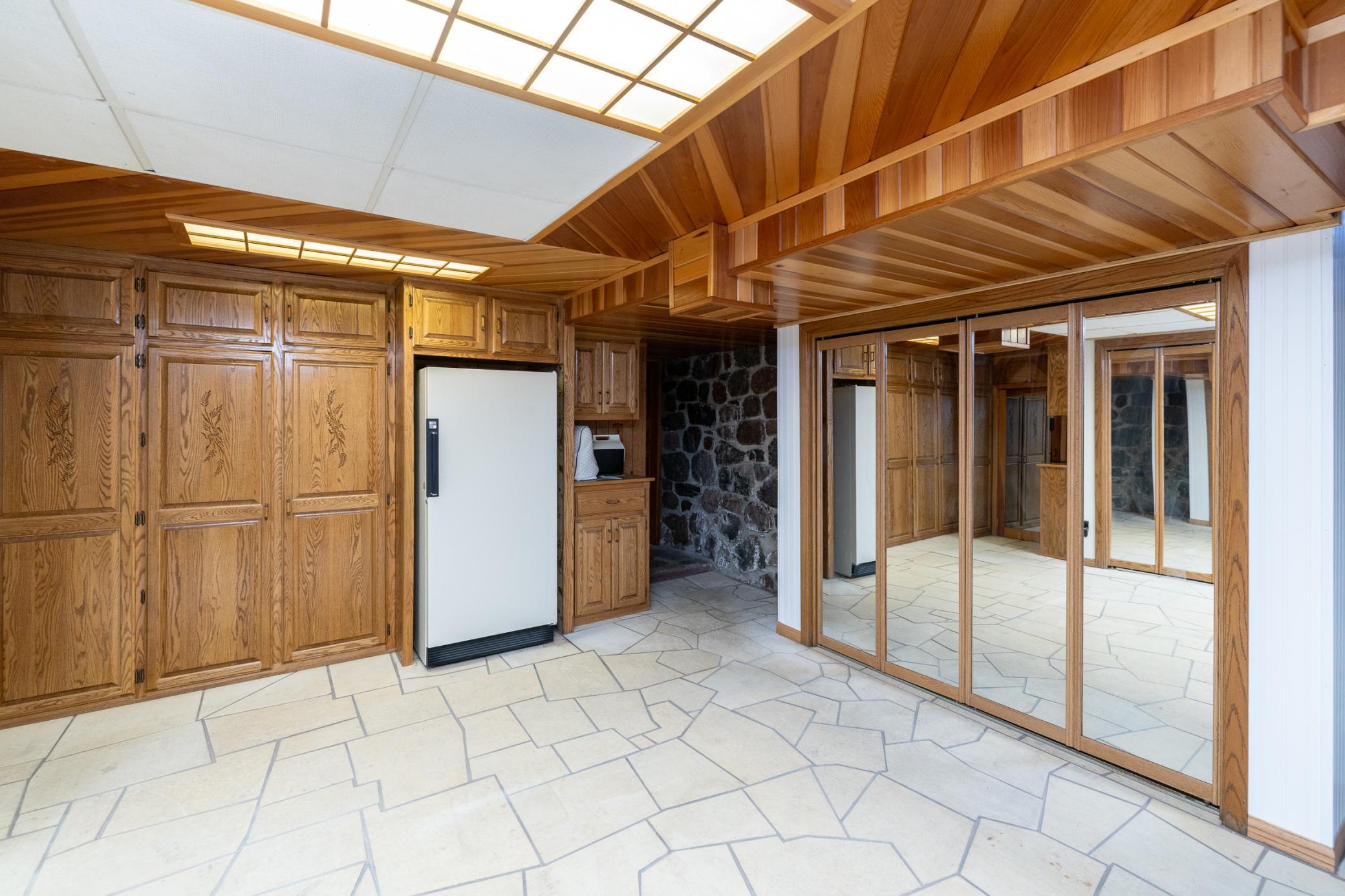 Lower level with space for additional freezer, storage closet, oak cabinets and more