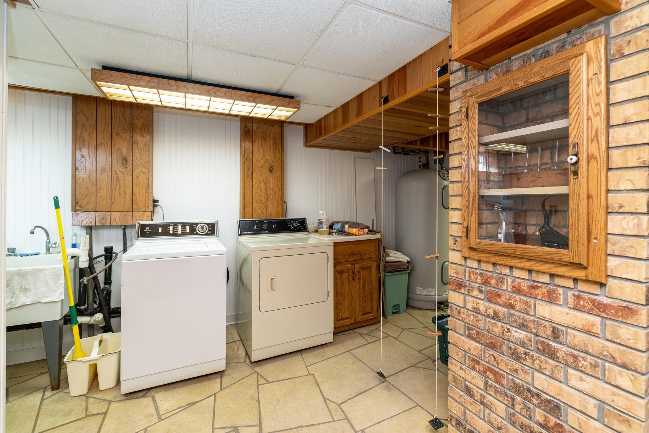 Large finished lower level laundry/ storage area.