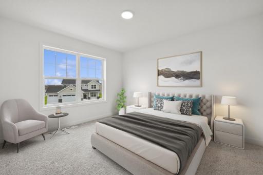 (Photo of a decorated model, actual finishes will vary) One of three generously sized upper level secondary bedrooms with spacious closets.