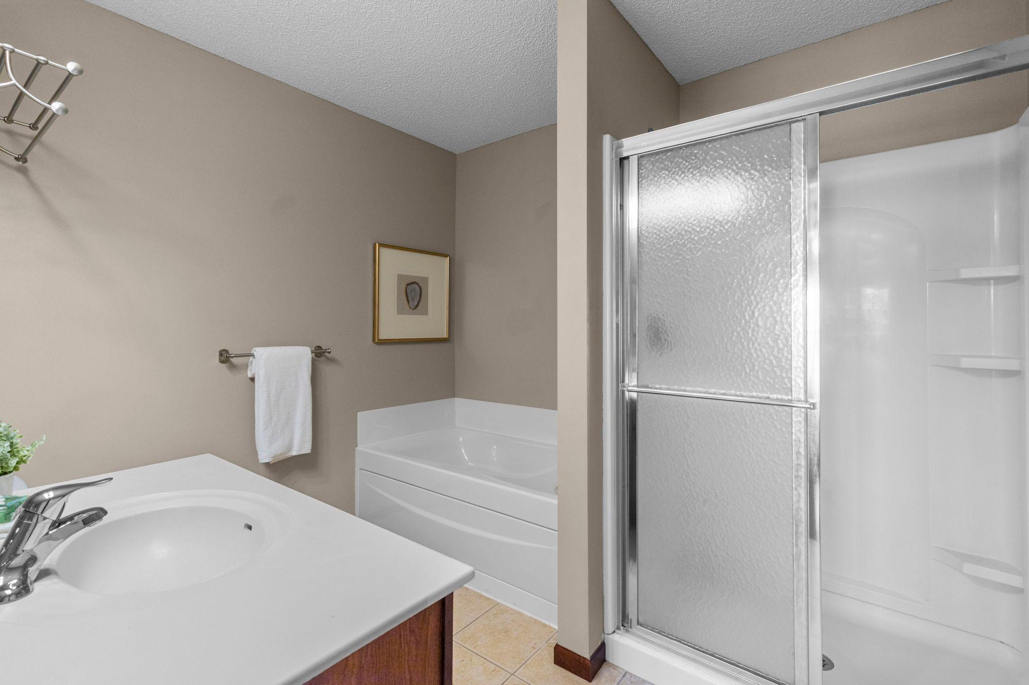 Private primary bath has a separate shower and tub