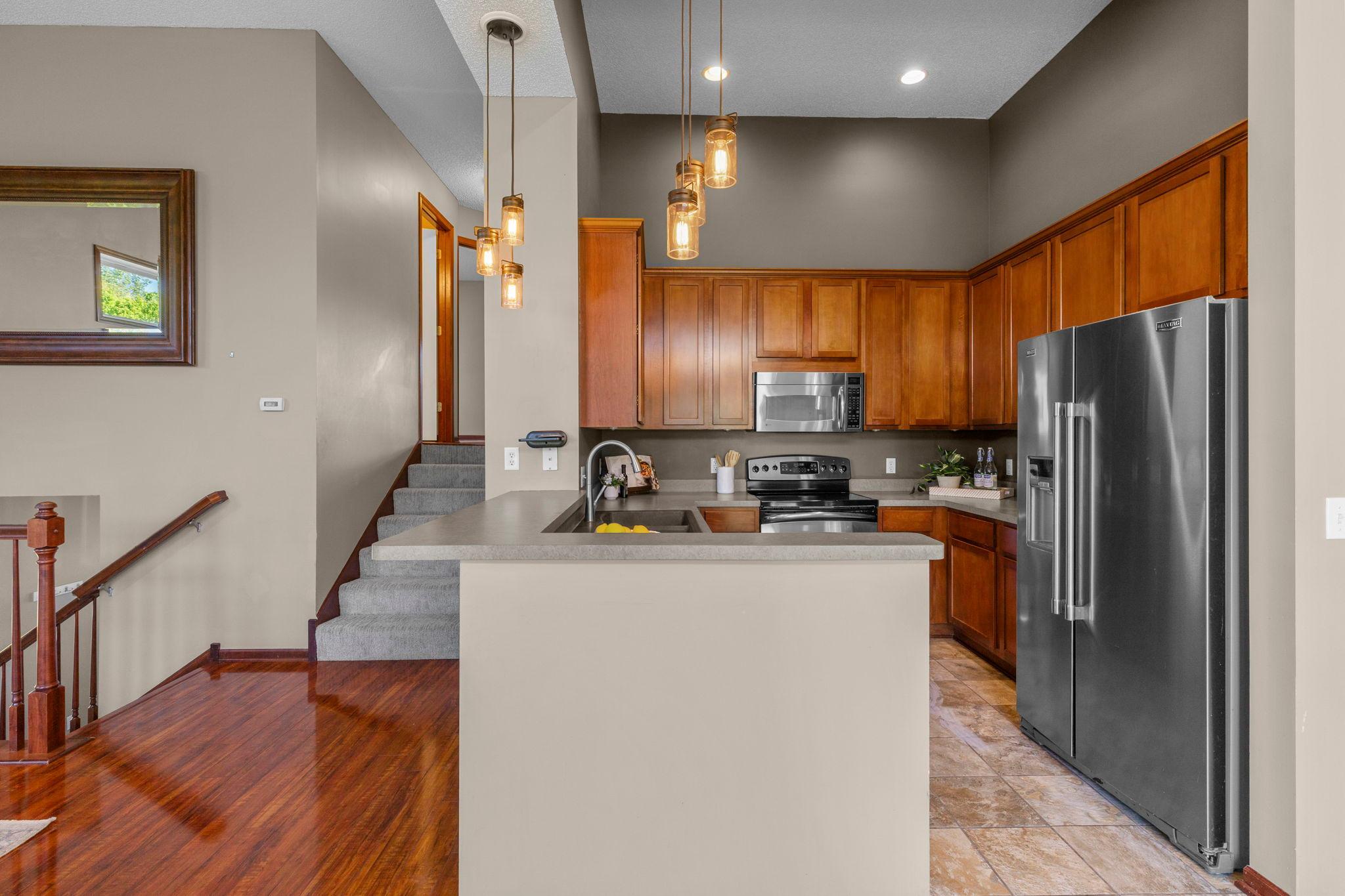 Tasteful kitchen with stainless steel appliances and tile floors