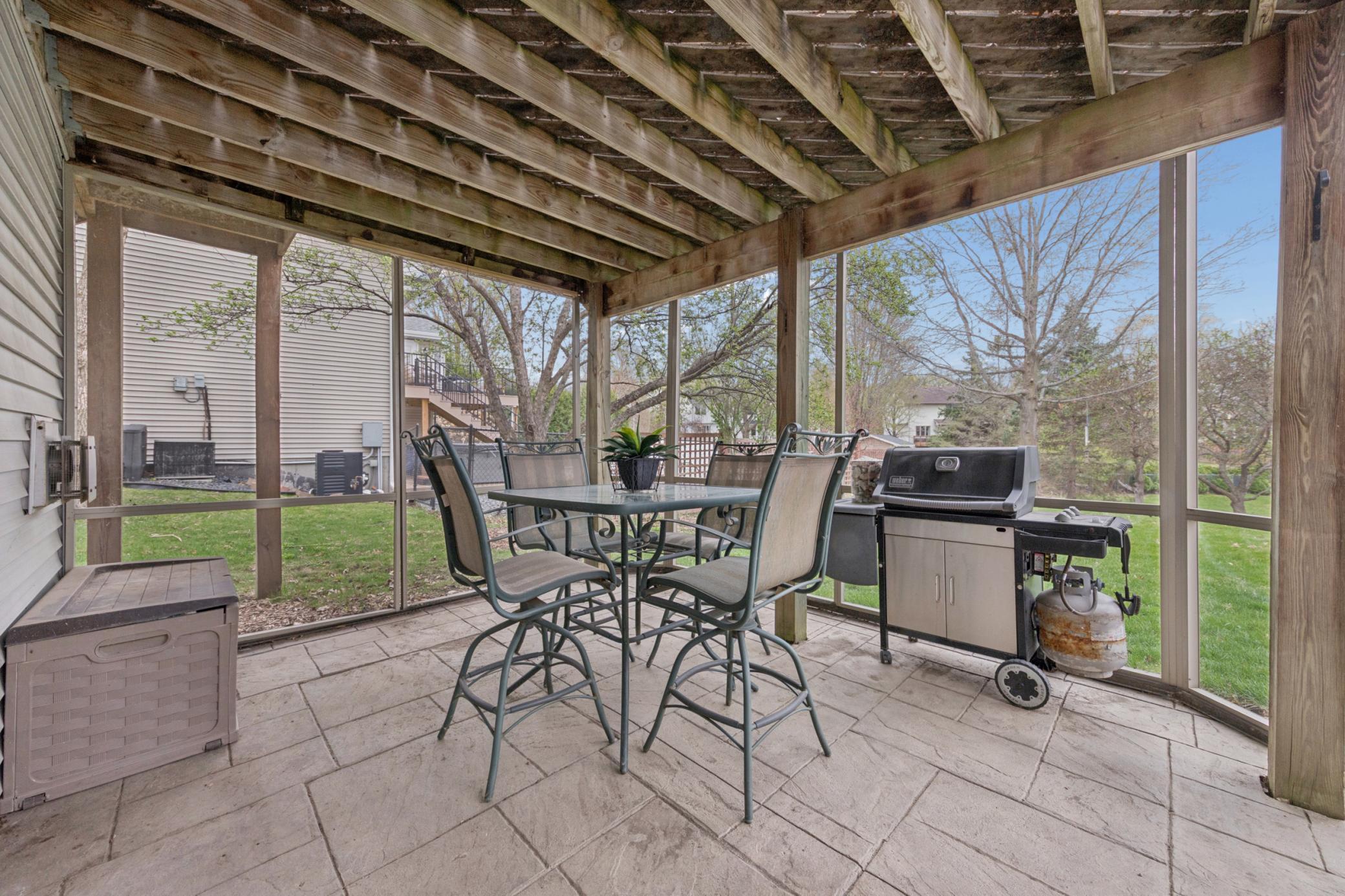 Enjoy the outdoors without the bugs in the screen porch with stamped concrete floor.