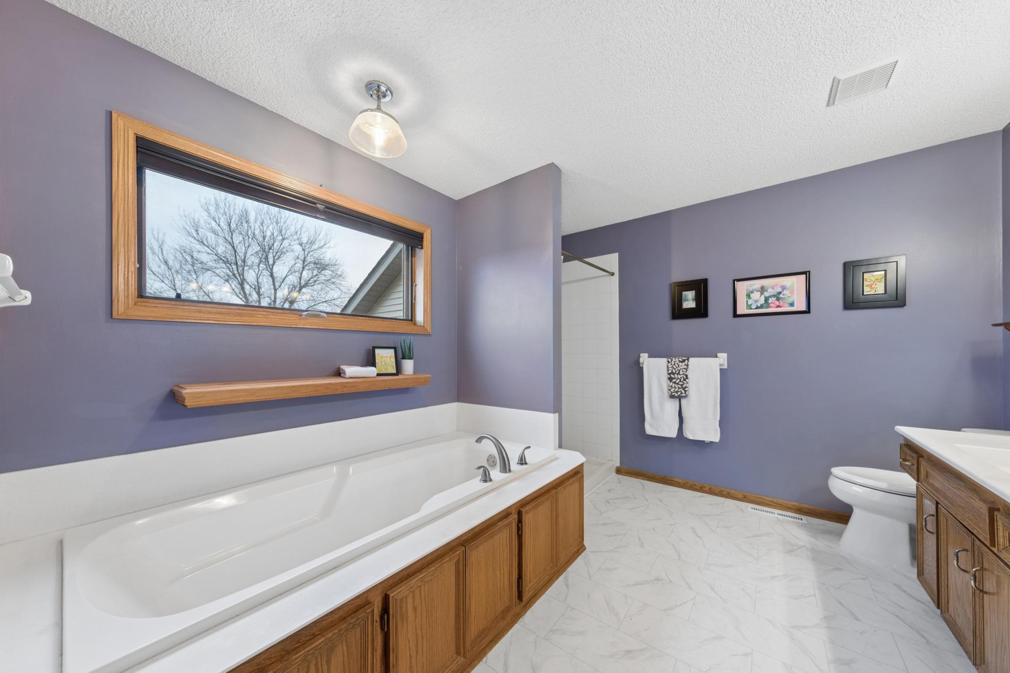 Full, private primary bath with separate soaking tub and shower.