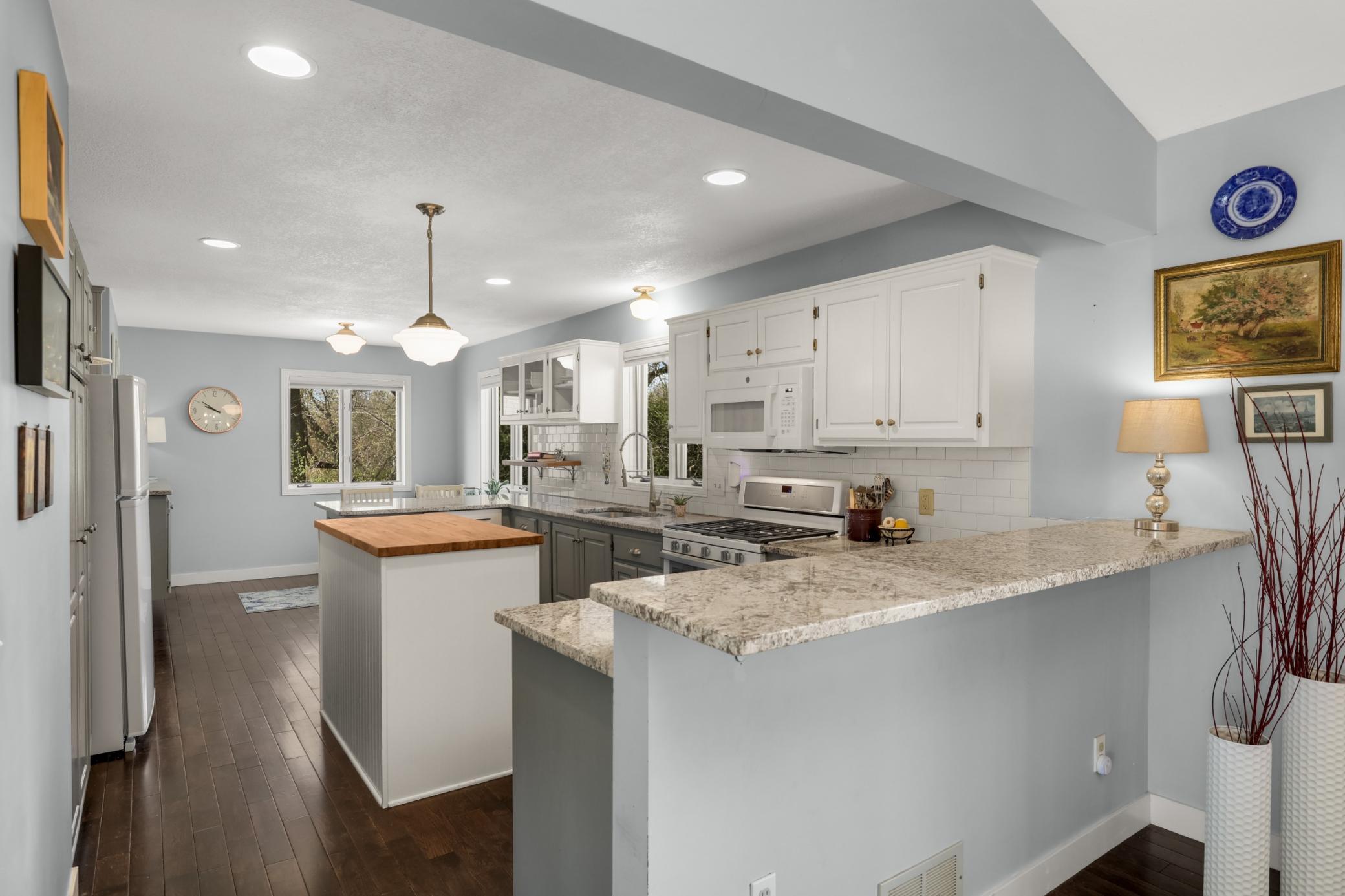 Granite countertops and butcher block center work space