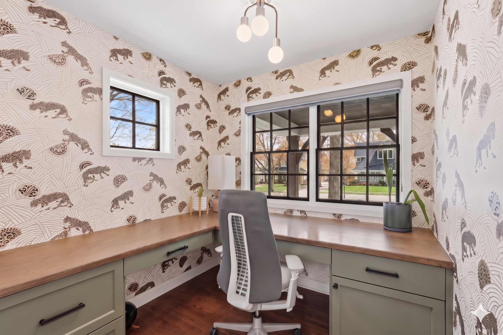 The main floor office includes built-ins and the perfect touch of designer wallpaper overlooking the front porch.