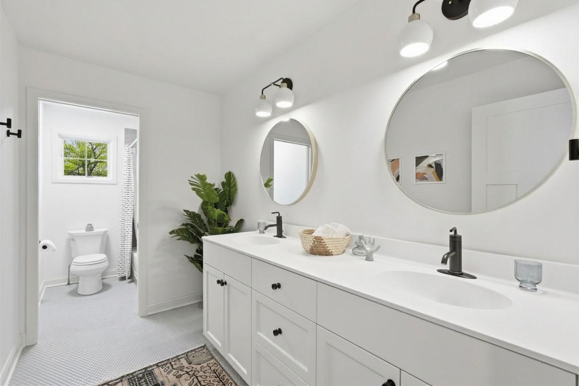 Upper level full bathroom with beautiful penny tile floors.