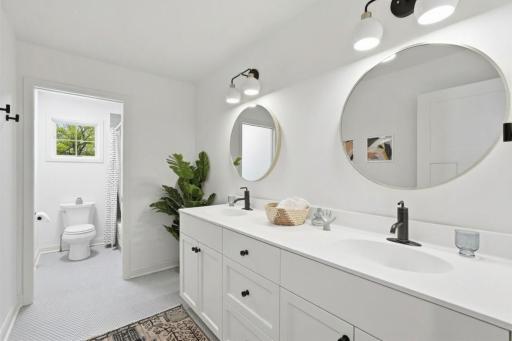 Upper level full bathroom with beautiful penny tile floors.