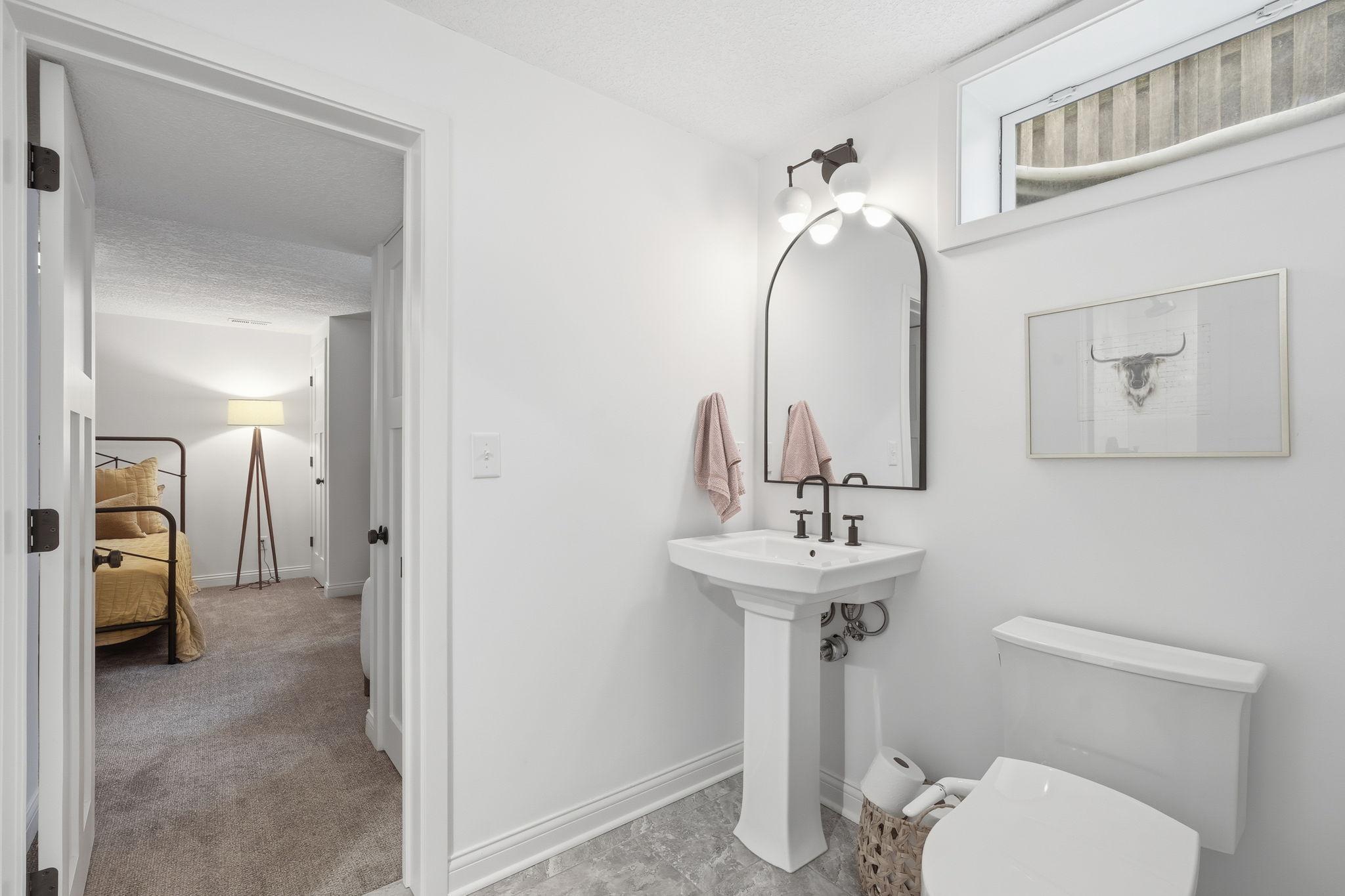 Lower level bathroom can be accessed from the bedroom or hallway off of the family room.