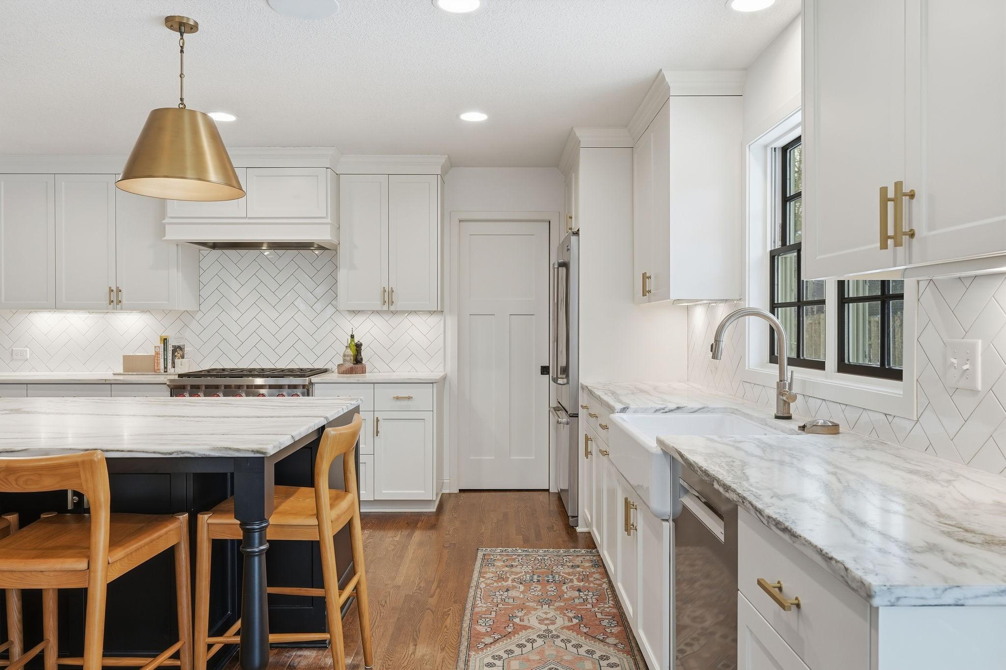 The kitchen pantry door is located near the refrigerator.