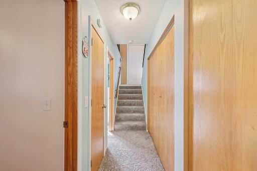 The open door the left of the stairs in this photo is the primary bedroom