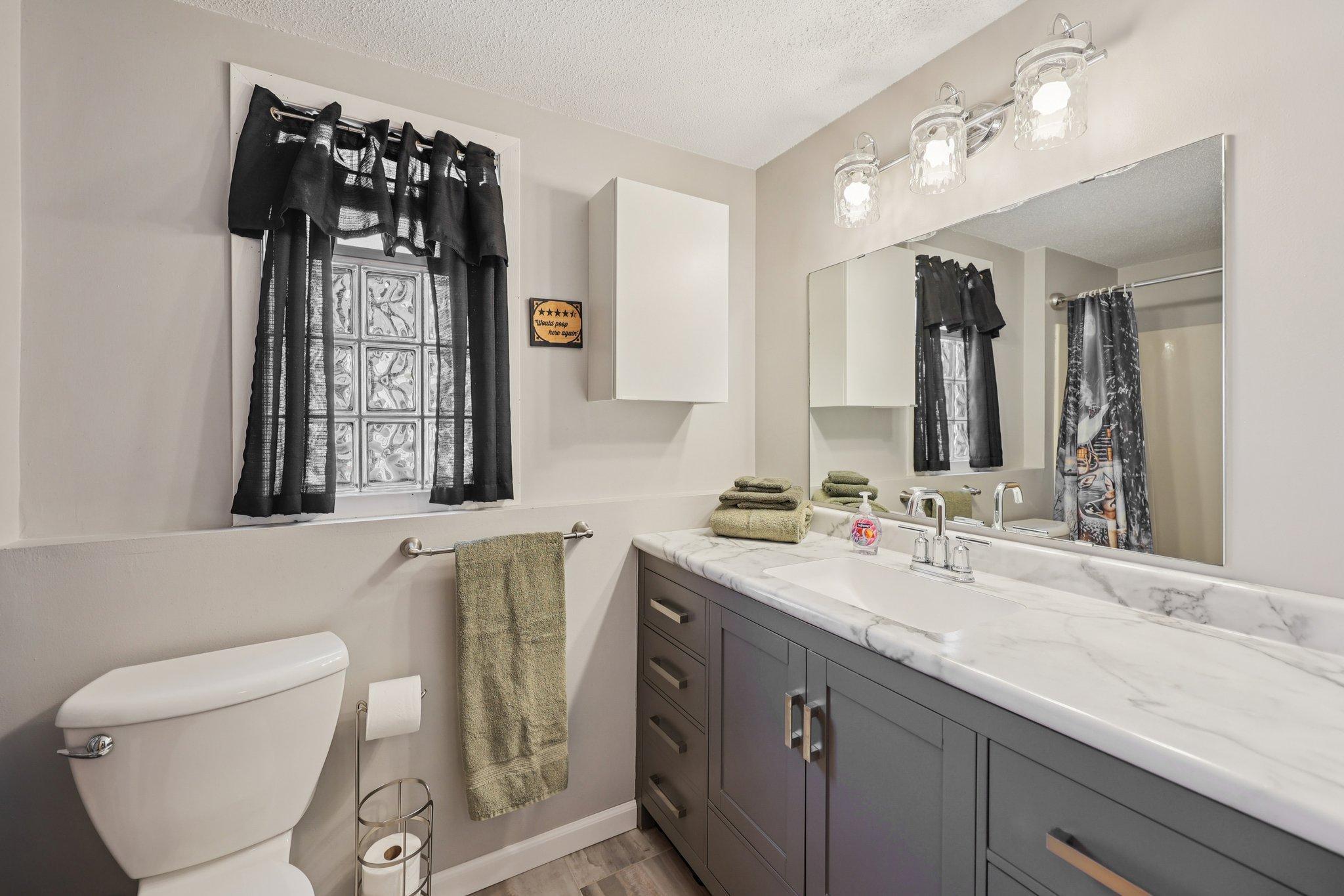 Lower level full bath at the end of the hall