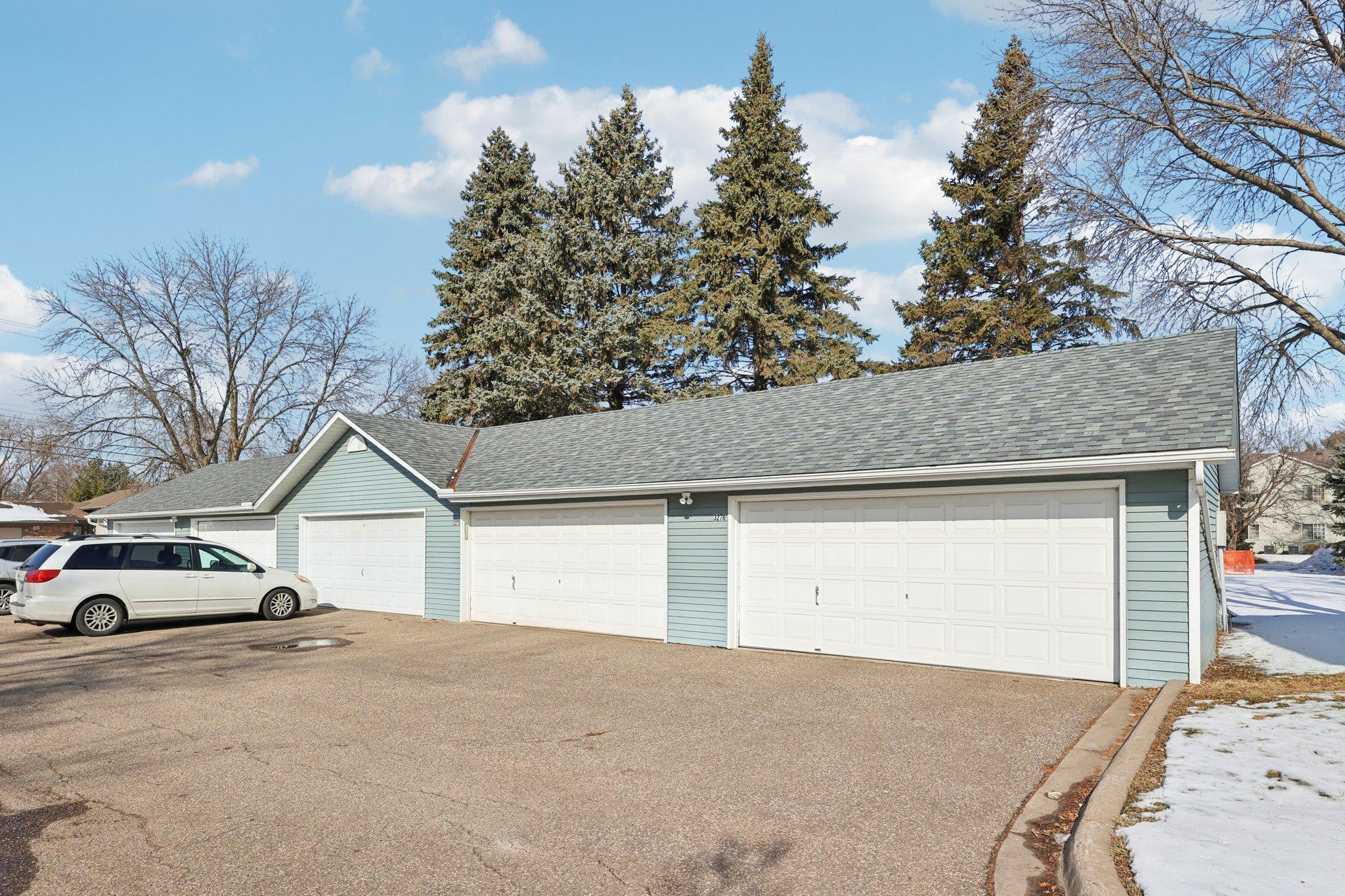 4th garage to the left in this photo. The 2 car garage has a newer door and opener, and has electric. The garage for this unit has the house numbers on it.
