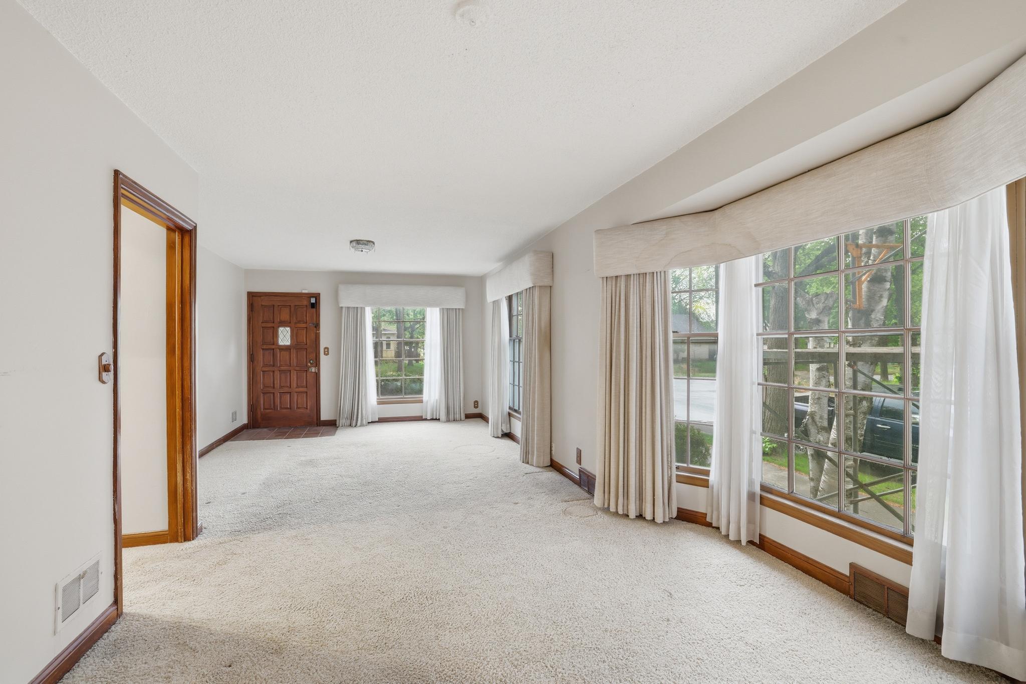 Large living room with hardwood floors under carpet