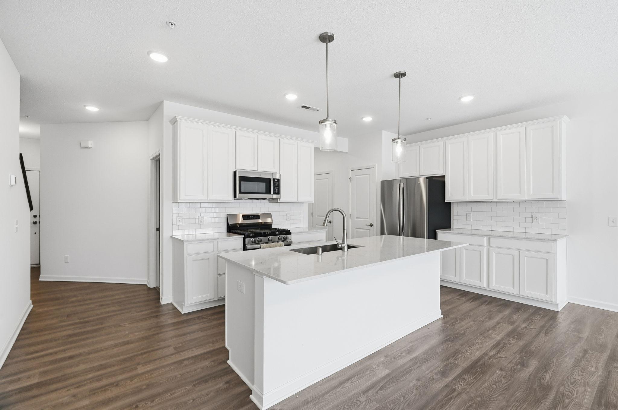 Stone countertops and tile backsplash making cleanup a breeze!