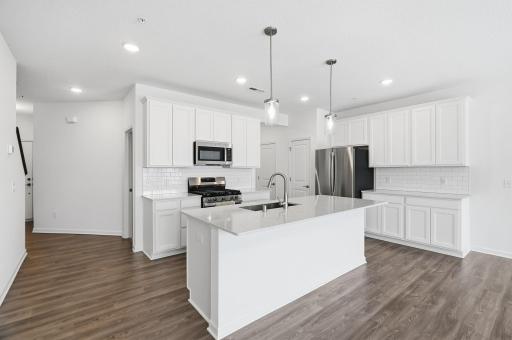 Stone countertops and tile backsplash making cleanup a breeze!