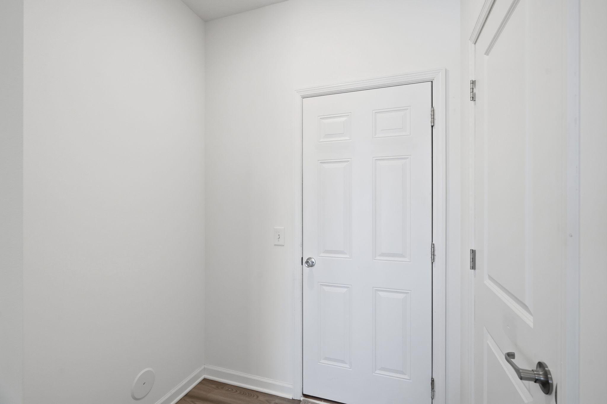 garage entry area with closet and room for a bench