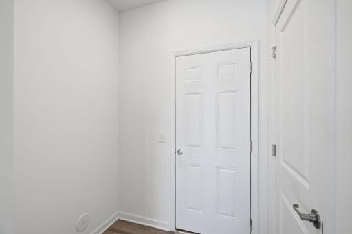 garage entry area with closet and room for a bench