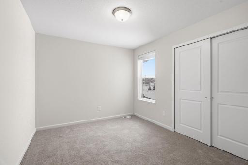 Bedroom 2-bedrooms 2 & 3 are tucked at the other end of the upper level from the primary