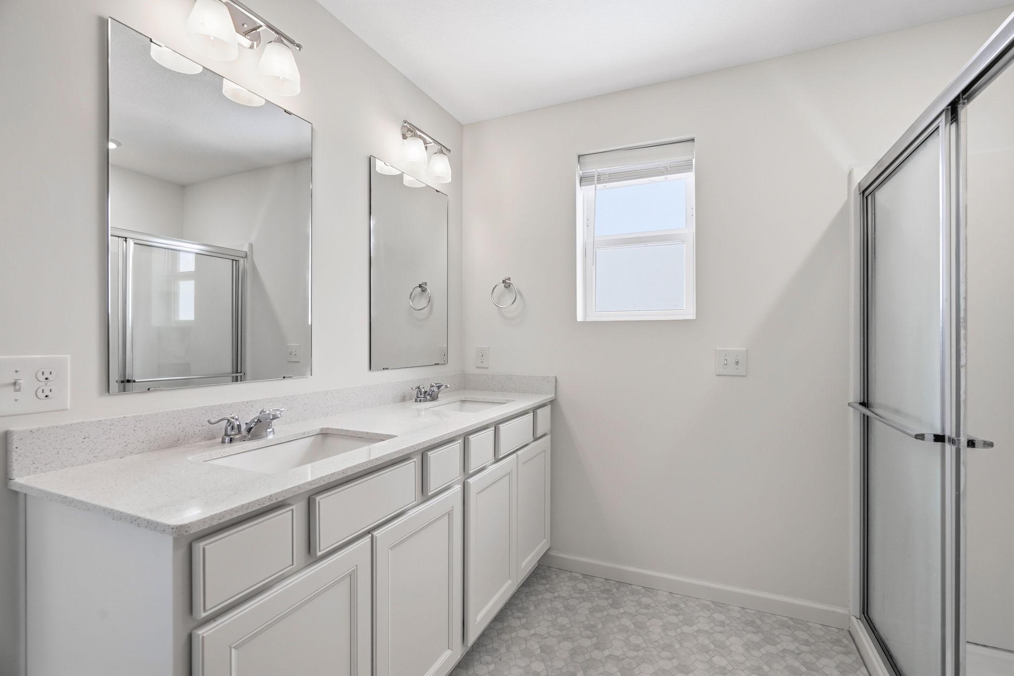 Primary ensuite with double sinks and large shower